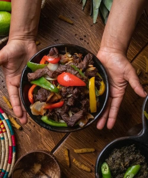 hands-holding-bowl-fajita-mexican-food_181624-45672